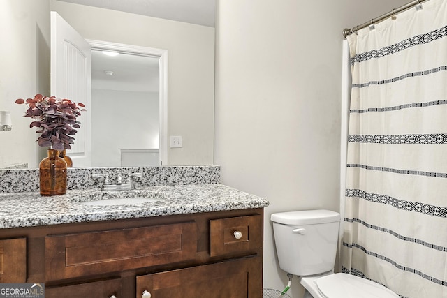 bathroom featuring vanity and toilet