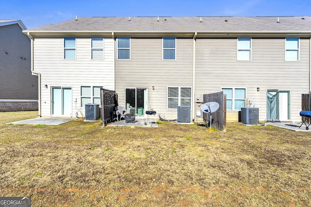 back of house featuring a lawn, a patio, and central AC