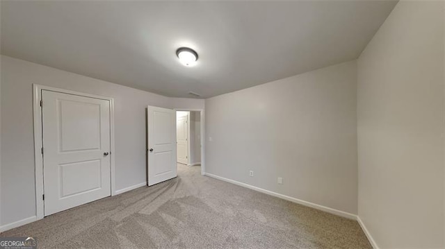 unfurnished bedroom featuring light colored carpet