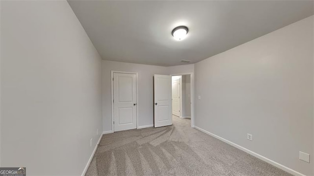 unfurnished bedroom with light carpet