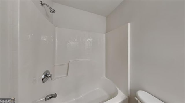 bathroom featuring toilet and bathtub / shower combination