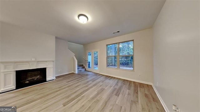 unfurnished living room featuring light wood-type flooring