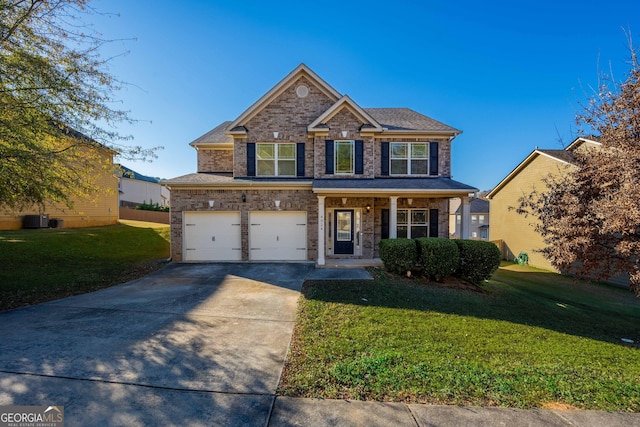 view of front of home with covered porch, a garage, and a front lawn