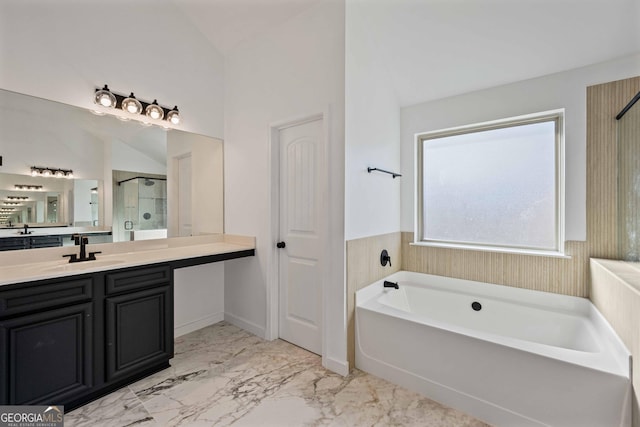 bathroom featuring vanity, independent shower and bath, and vaulted ceiling