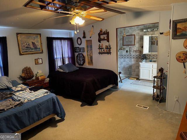 bedroom featuring carpet flooring, ceiling fan, and vaulted ceiling