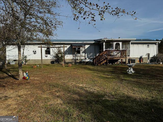 back of house with a lawn