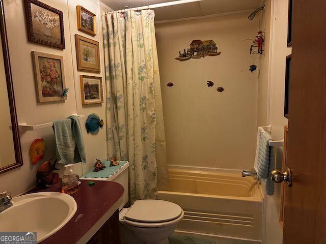 full bathroom with vanity, shower / bathtub combination with curtain, and toilet