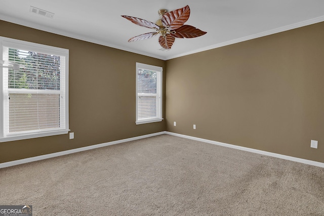 carpeted empty room featuring crown molding and ceiling fan