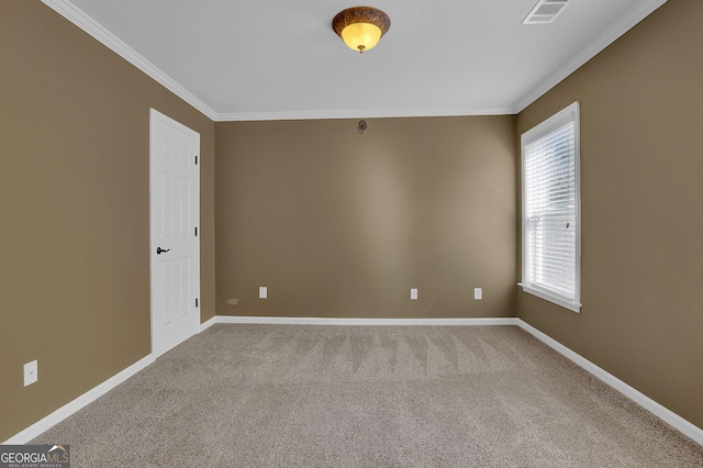 carpeted spare room featuring ornamental molding