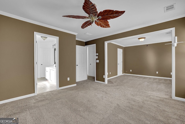 unfurnished bedroom featuring light carpet, ensuite bath, ceiling fan, and crown molding