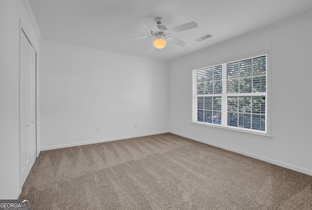 spare room featuring carpet flooring, ceiling fan, and ornamental molding