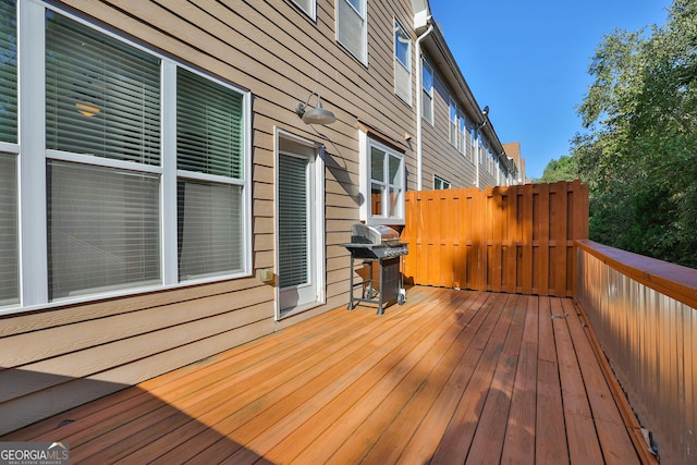 wooden terrace featuring a grill