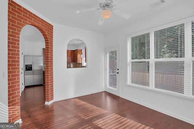 spare room featuring ceiling fan, dark hardwood / wood-style flooring, and ornamental molding