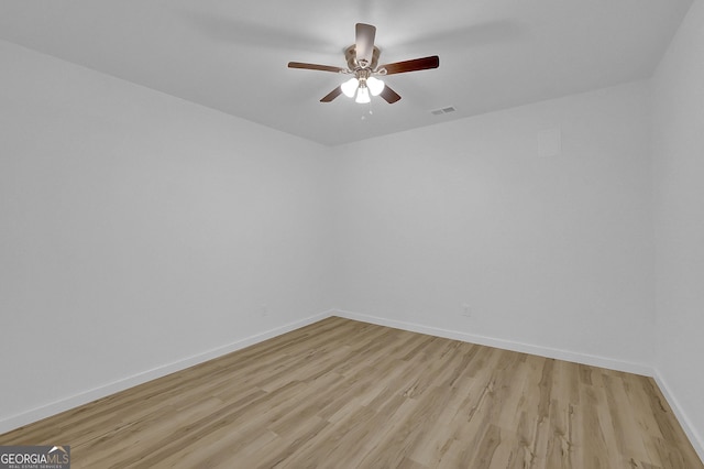 empty room with light hardwood / wood-style flooring and ceiling fan