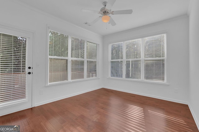 unfurnished sunroom featuring ceiling fan