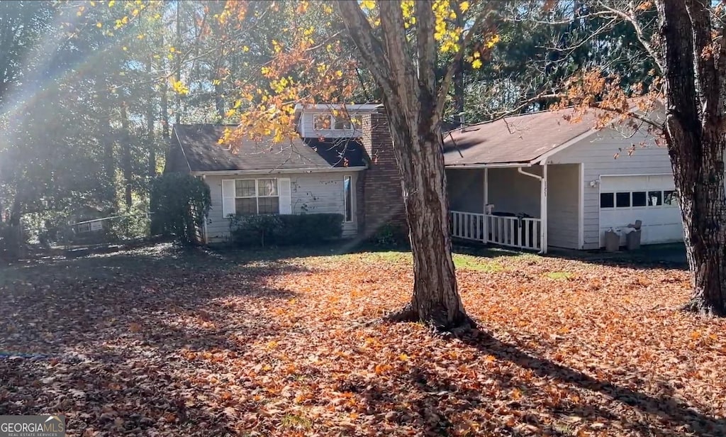 ranch-style house featuring a porch and a garage