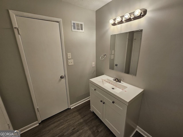 bathroom featuring wood-type flooring and vanity