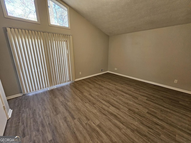 bonus room featuring vaulted ceiling, a textured ceiling, and dark hardwood / wood-style floors