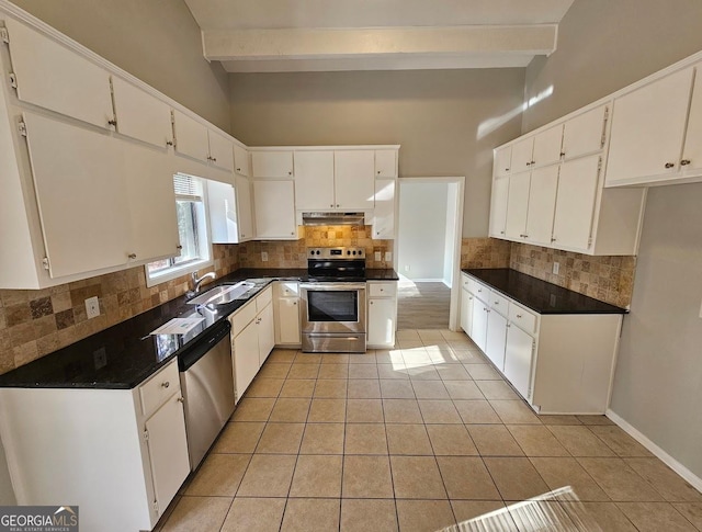 kitchen featuring beam ceiling, white cabinetry, and stainless steel appliances