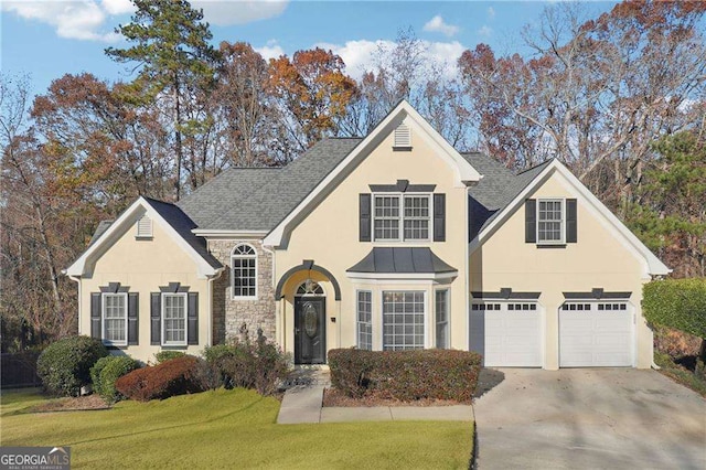 front of property featuring a front lawn and a garage