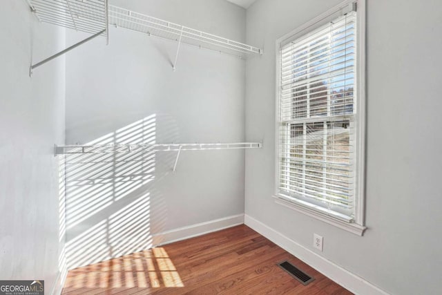 spacious closet featuring hardwood / wood-style flooring