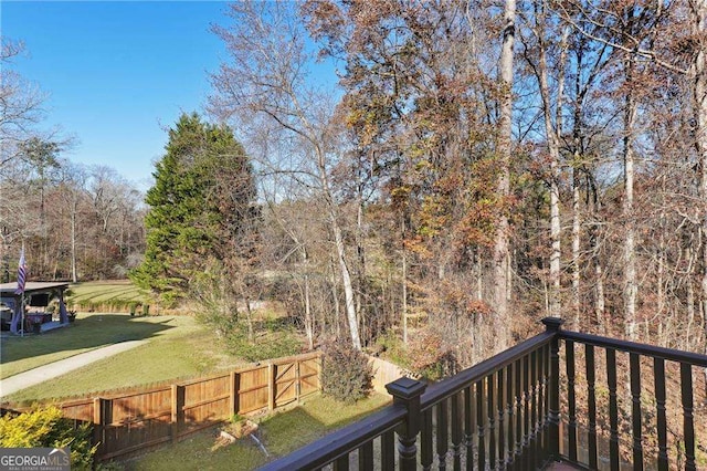 wooden deck featuring a lawn