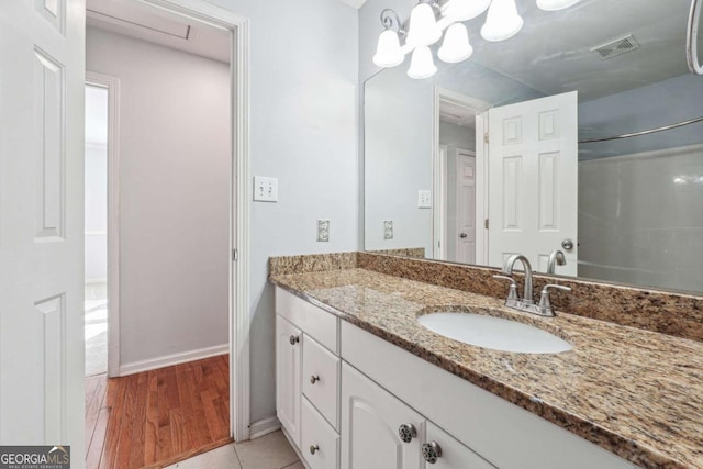 bathroom with hardwood / wood-style floors and vanity