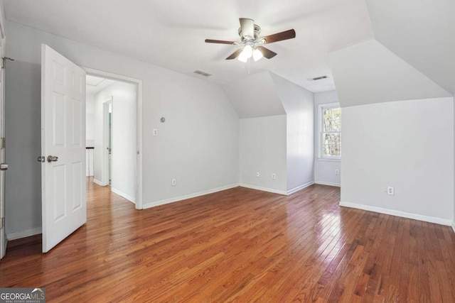 additional living space with ceiling fan, wood-type flooring, and lofted ceiling