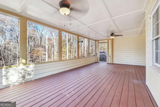 unfurnished sunroom with ceiling fan