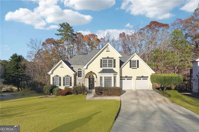 front facade with a garage and a front lawn