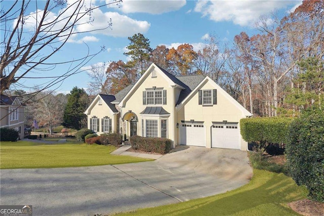 view of property with a front lawn and a garage