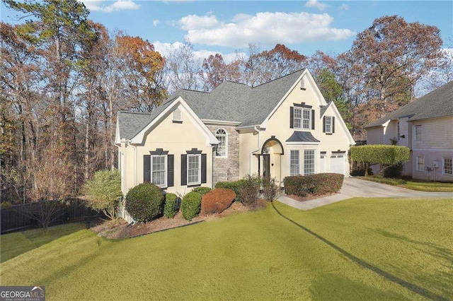 view of front of house with a garage and a front lawn