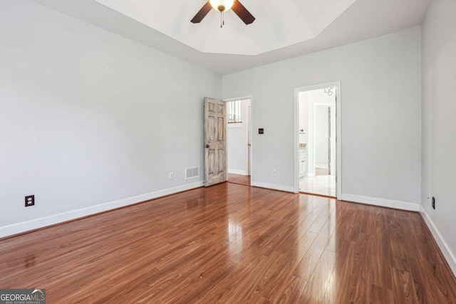 unfurnished bedroom with ensuite bath, ceiling fan, and hardwood / wood-style floors