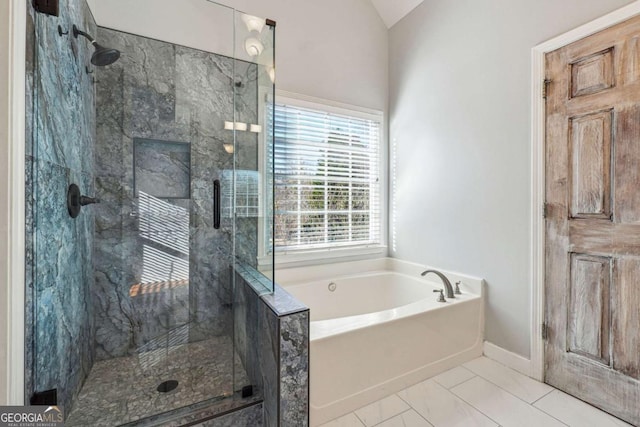 bathroom with tile patterned floors, independent shower and bath, and lofted ceiling