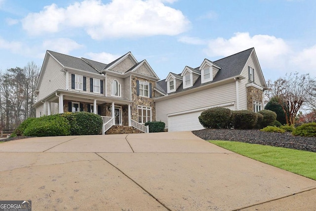 view of front of property featuring covered porch and a garage