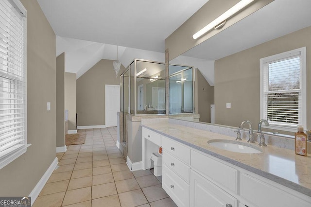 bathroom with tile patterned flooring, vanity, and vaulted ceiling