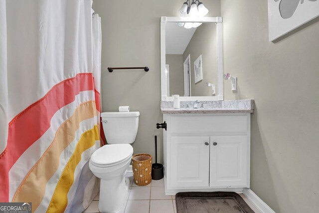 bathroom featuring toilet, vanity, and tile patterned floors