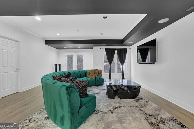 living room featuring hardwood / wood-style flooring and ornamental molding