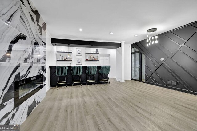 interior space featuring hanging light fixtures and light hardwood / wood-style flooring