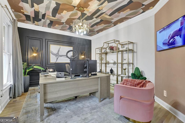 home office with light wood-type flooring, an inviting chandelier, and crown molding