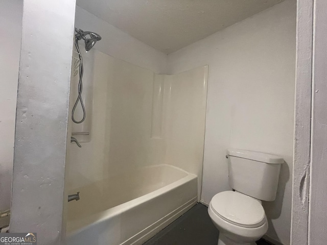 bathroom with bathtub / shower combination and toilet