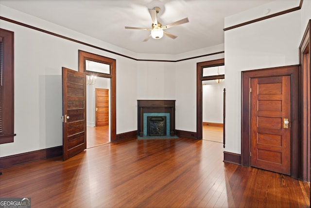 unfurnished living room featuring ceiling fan and dark wood-type flooring