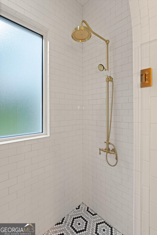 bathroom with tiled shower