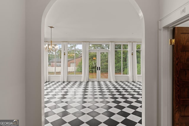 interior space with french doors and an inviting chandelier