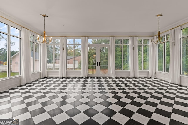 unfurnished sunroom featuring a notable chandelier and french doors