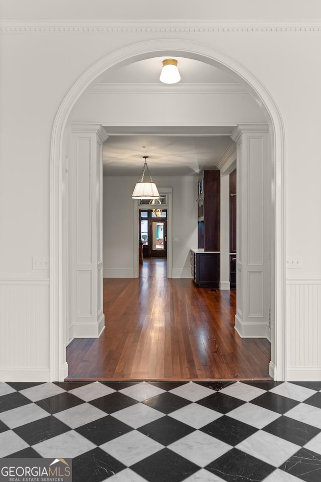 corridor featuring dark hardwood / wood-style floors and crown molding