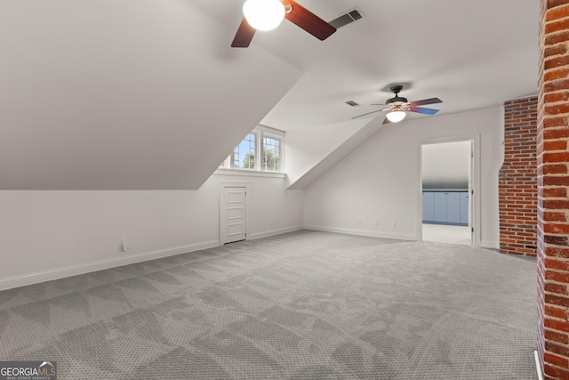 bonus room with ceiling fan, light colored carpet, and vaulted ceiling