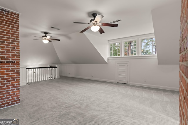 bonus room featuring ceiling fan, lofted ceiling, and light carpet