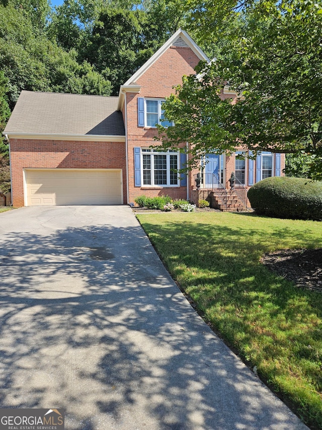 view of front of home featuring a garage and a front lawn