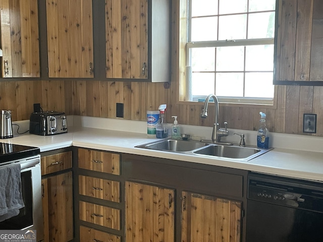 kitchen with stainless steel range with electric cooktop, dishwasher, sink, and wooden walls